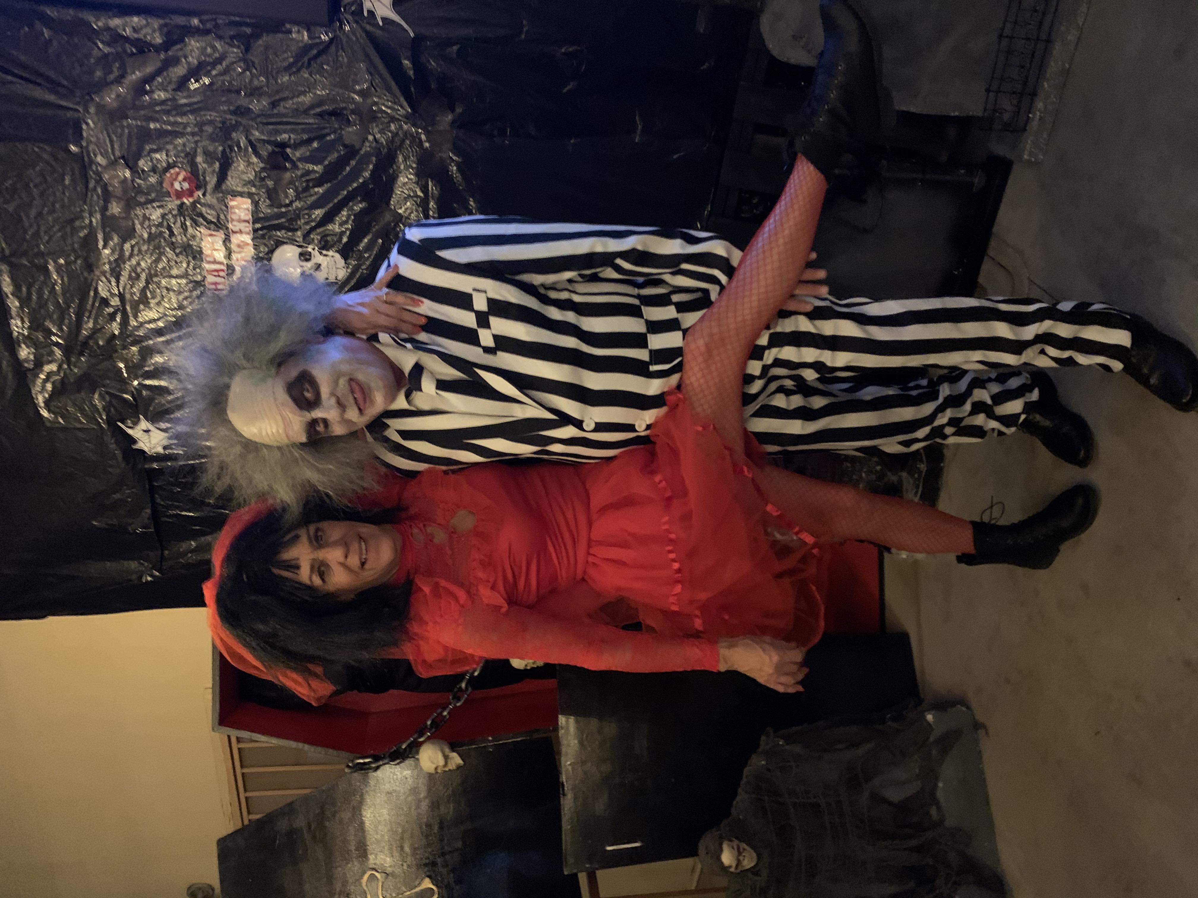 people dressed up as BeetleJuice and a woman in red