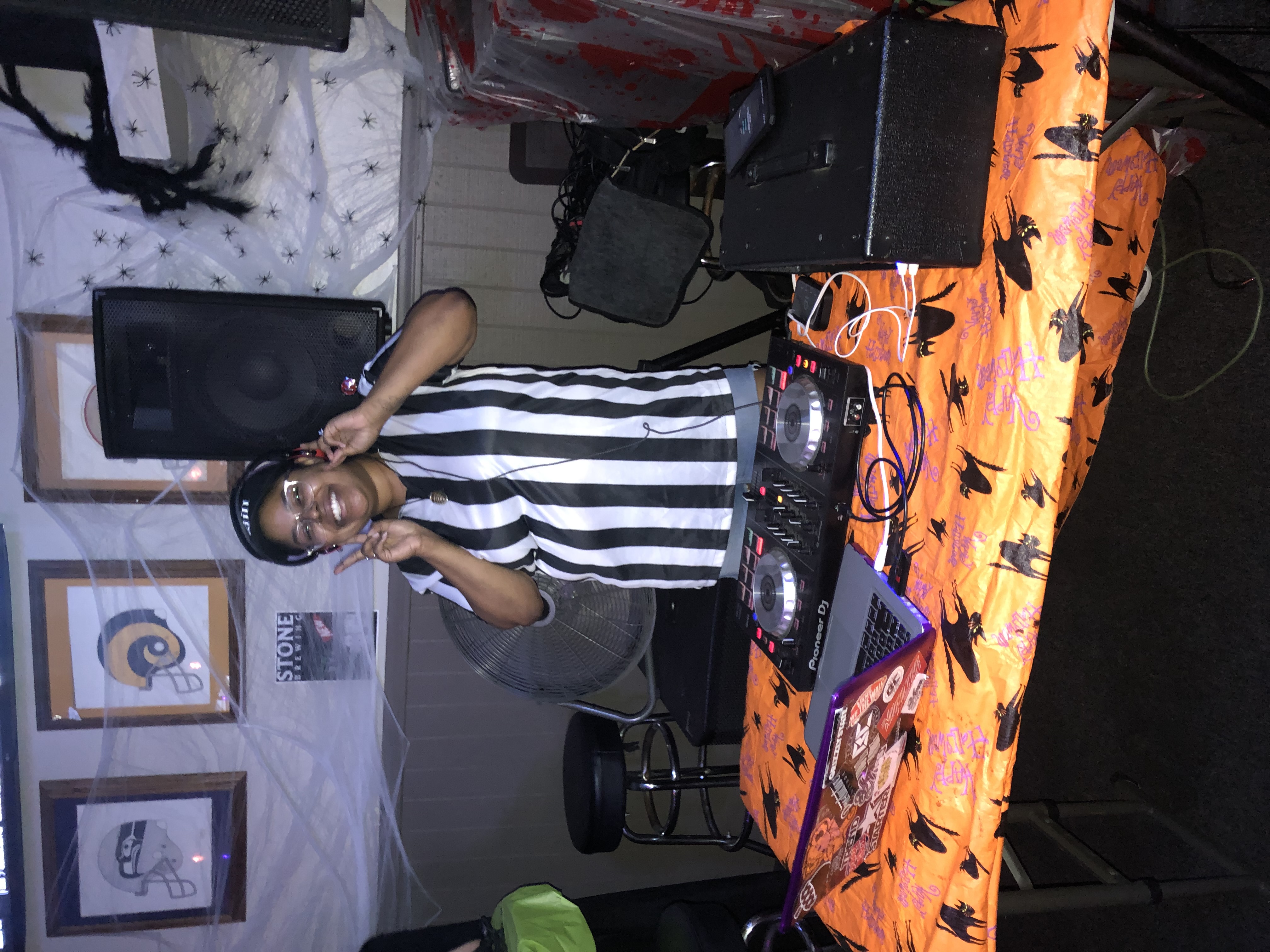 a performing DJ dressed up as referee